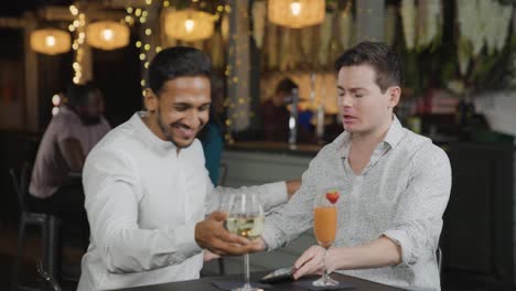 medium shot of man approaching other man in bar