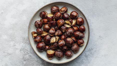 roasted chestnuts on a plate over minimalist background