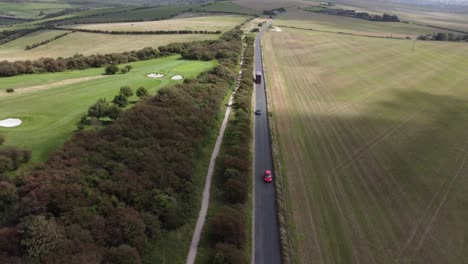 Red-Car-Driving-on-a-Country-Road,-England