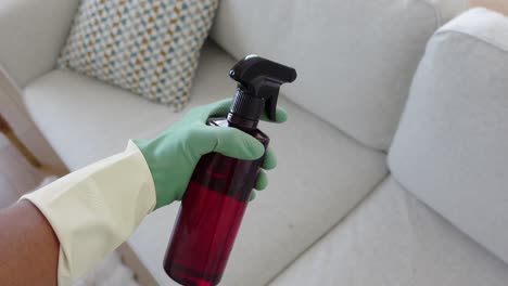 cleaning a sofa with spray bottle