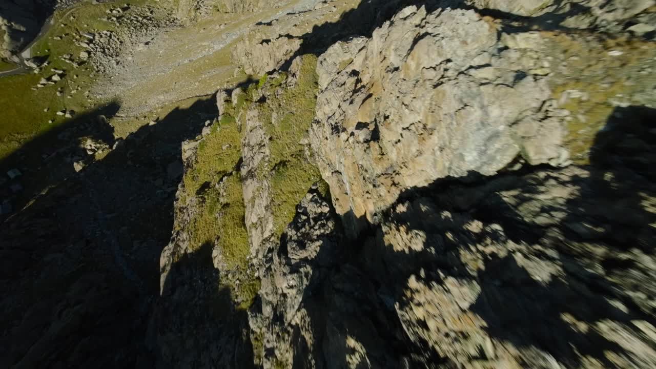 impresionante vuelo acrobático con un avión no tripulado rápido sobre la superficie rocosa de la montaña alpina de cima fontana en valmalenco