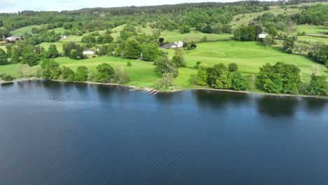 scenic lakeside landscape with paddleboarders and rolling green hills