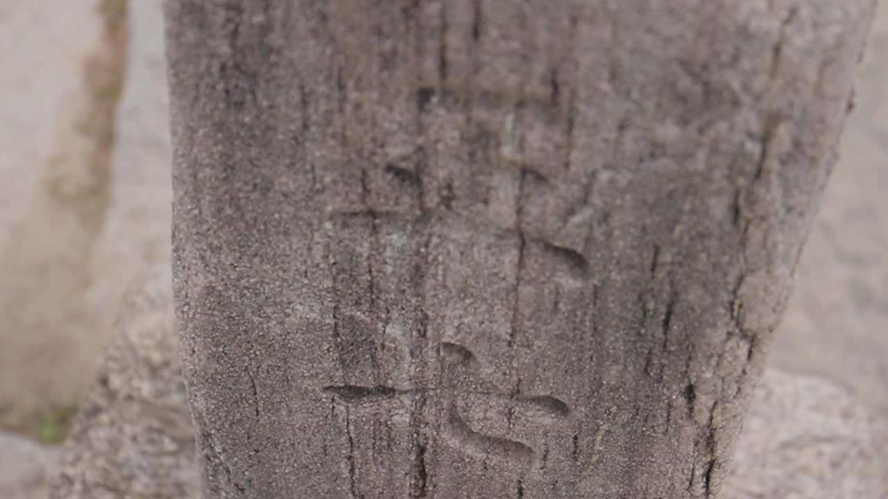 Close-up view of carved markings on a stone monument