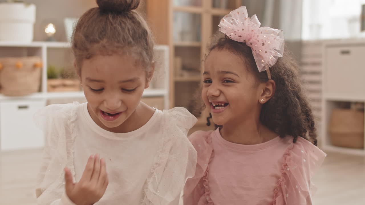 Girl Giving Sister Kiss on Cheek