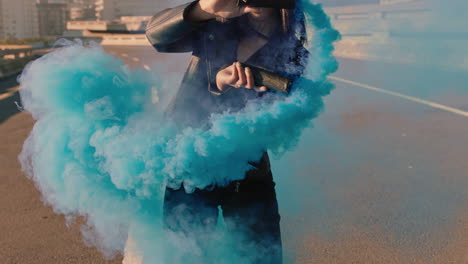 dancing woman waving blue smoke bomb in city street hip hop dancer girl celebrating creative freedom with dance slow motion