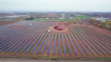 flying over wide setup of solar panels in lines , atwater, mn, usa