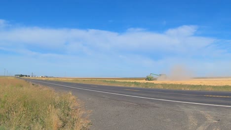 combine and grain wagon are harvesting wheat in eastern washington state