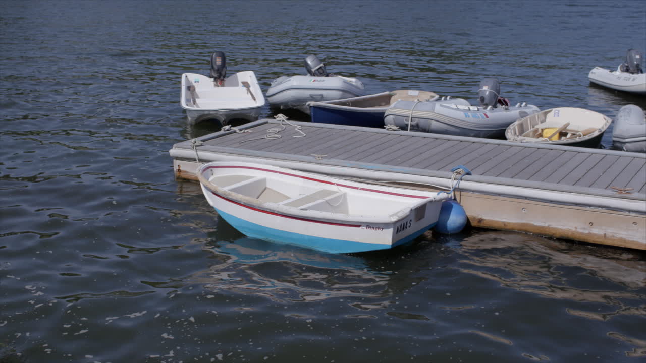 un bote y otros barcos en suaves olas en el lago en cape cod