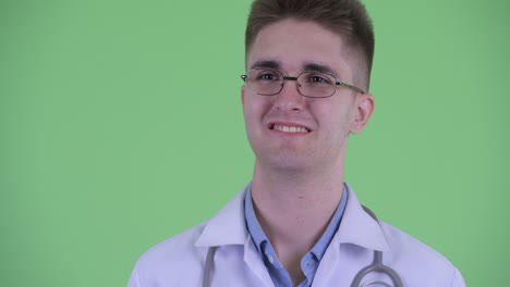 studio shot of young man doctor against green screen chroma key background
