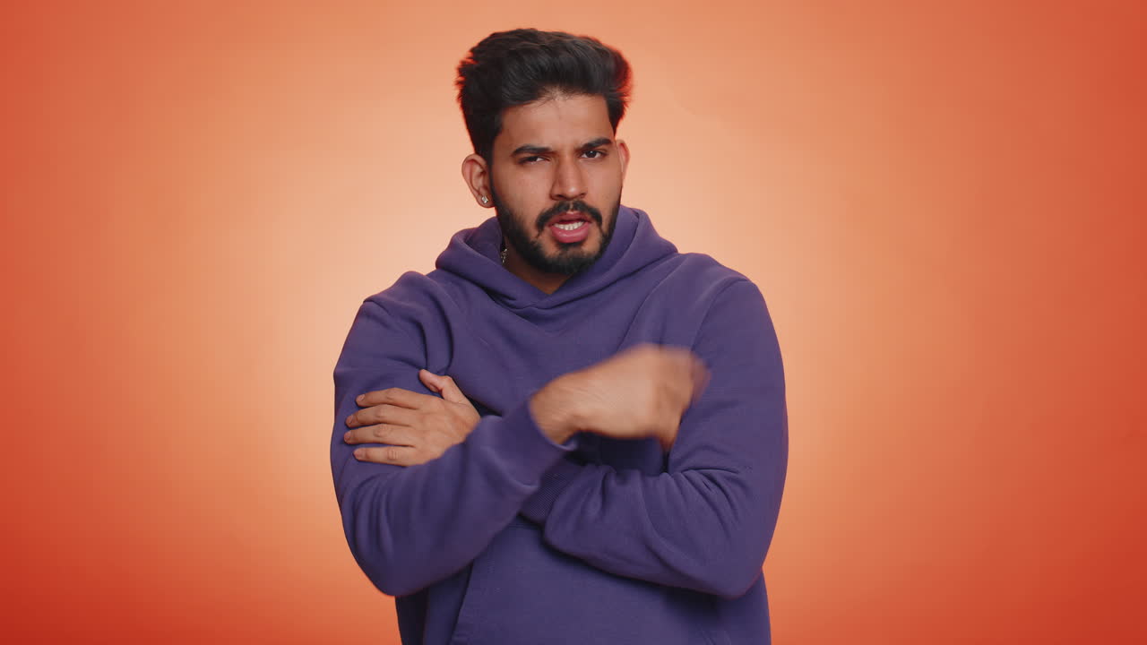 Man with a beard giving thumbs down