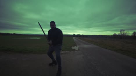 Modern-Black-Swordsman-Warrior-Awaiting-Battle-Opponent-in-Open-Field-Under-Grey-Sky,-Europe,-4K-|-Muscular,-Intimidating,-Shadow,-Figure,-Blurry,-Dark-Clothes,-Powerful,-Tense,-Guarded,-Stance