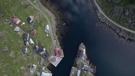 vista panorámica de un histórico pueblo de pescadores en el norte de noruega, nyksund, nubes que se reflejan en la tranquila superficie del agua dentro del puerto
