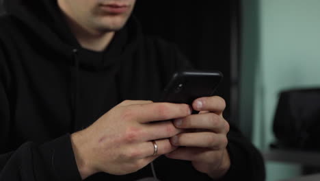 content creator typing on a phone in a studio