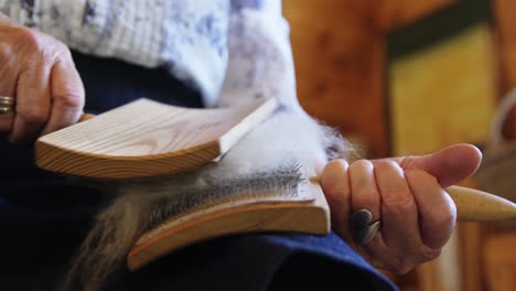 senior citizen brushing woollen pulp with brush 4k