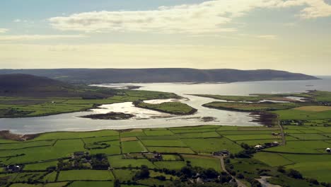 irish rural landscape, view from ballyvelaghan looking towards fanore, clare, ireland, august 2020, drone gradually tracks over fields facing west towards clare