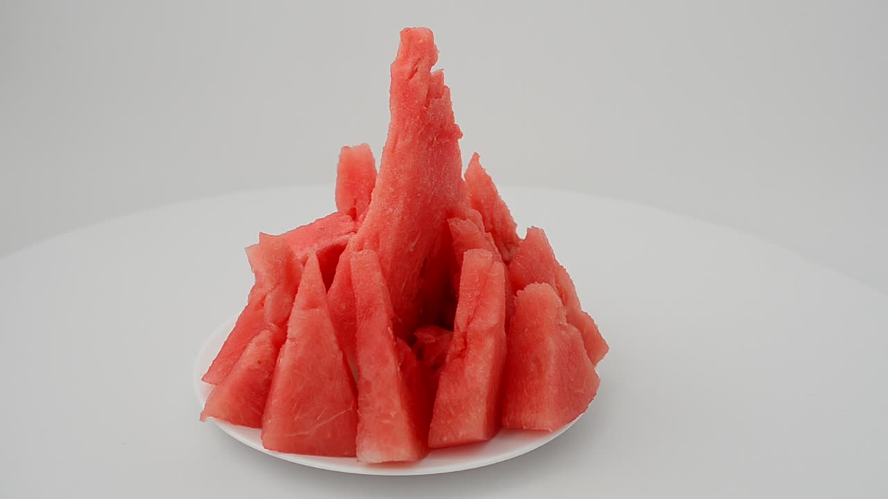 Shooting of a watermelon on a white background. Shooting in the movement