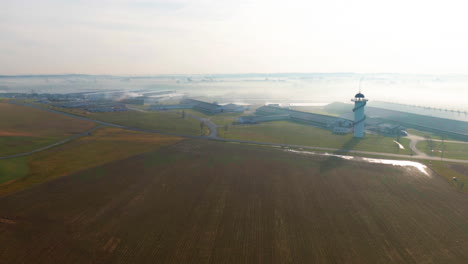 aerial hyperlapse, huge poultry and dairy farming operation on foggy winter morning, agriculture timelapse, united states farmland time lapse