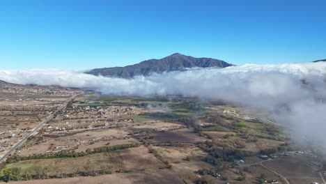 Aerial-view-of-clouds-over-the-town-of-Tafí-del-Valle-in-the-province-of-Tucumán,-Argentina