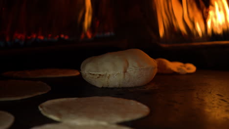 baking the traditional egypt flat bread in clay oven