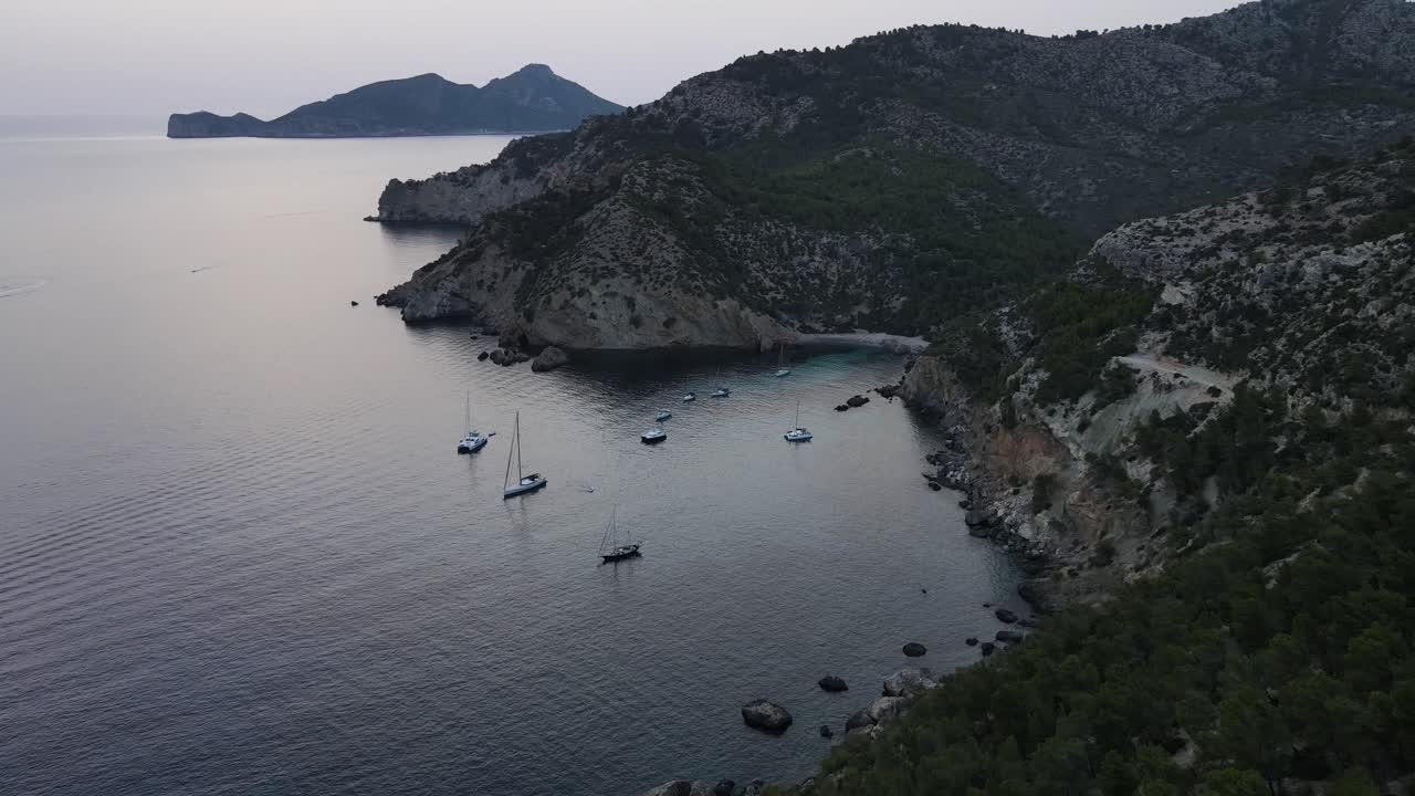 Drone view of cliffs and looks Sailboats Docked in Cala D'egos Beach, Spain