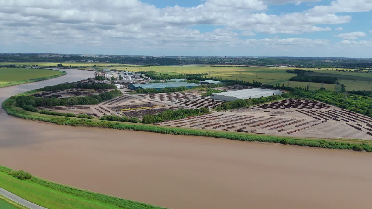 Aerial Drone Shot of Cargo Ships Docked at River Trent Port with Tankers and Heavy Machinery in Lincolnshire, UK