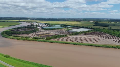aerial drone shot of cargo ships docked at river trent port with tankers and heavy machinery in lincolnshire, uk