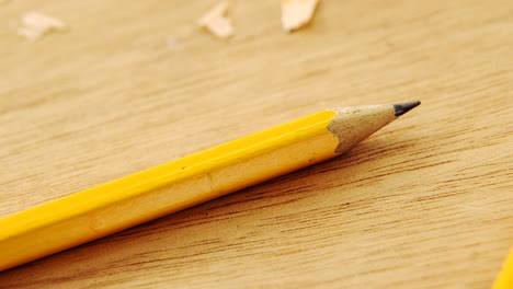 broken yellow pencil and sharpener on wooden background