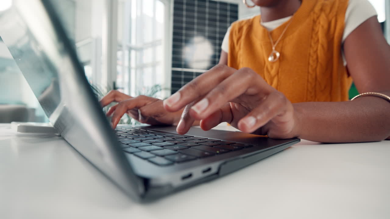 Woman's Hands Typing on Laptop Keyboard in Office