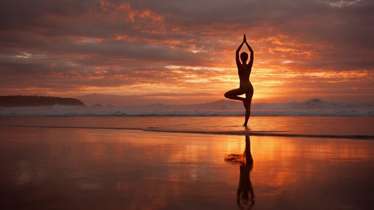 A Serene Sunset Yoga Pose on the Beach: Embracing Tranquility and Connection with Nature Amidst Breathtaking Skies and Reflective Waters
