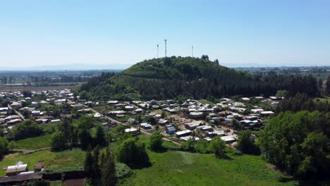 AERIAL:-hill-surrounded-of-small-village-in-countryside