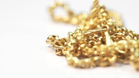 closeup shot of gold necklaces with rotating