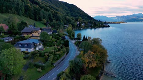 Aerial-view-of-a-small,-colorful-town-nestled-on-the-shore-of-a-sparkling-lake