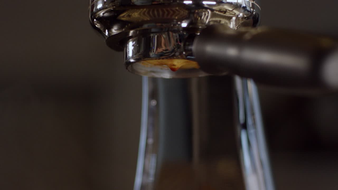 Premium stock video Espresso drips from a machine