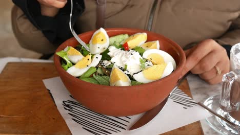 person eating a healthy egg salad