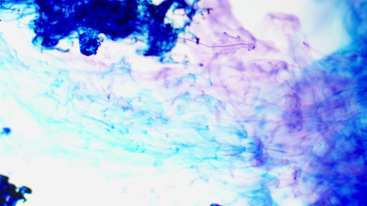 Purple And Blue Paint Or Dye Dropped Into Water Against White Background To Create Swirling Colourful Smoke Background 2