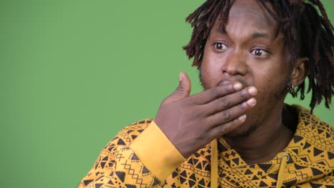young handsome african man looking shocked