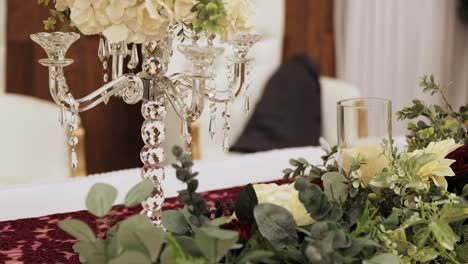 flower arrangements on white table at indoor wedding reception 1080p 60fps