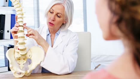 female explaining the spine to female patient