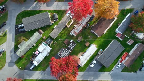 manufactured homes in usa trailer park with bright colorful autumn foliage on trees in fall