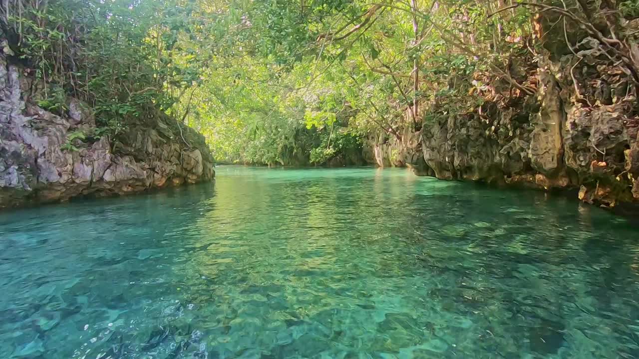Narrow clear water passage to a secret lagoon
