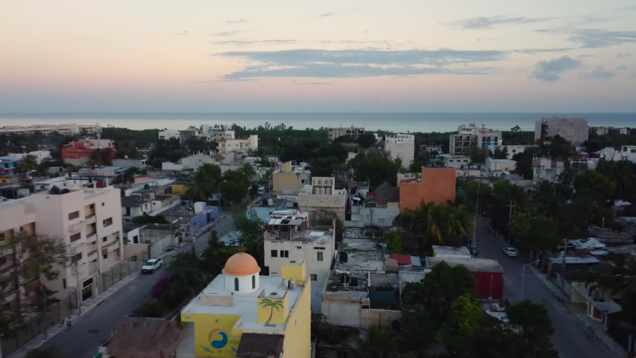 Small mexican town boardering the sea during a sunset, Playa del Carmen