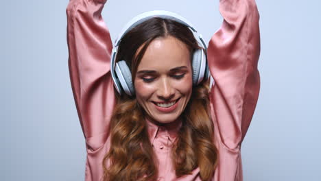 Businesswoman-dancing-in-headphones.-Professional-listening-music-in-earphones