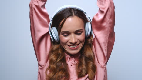 businesswoman dancing in headphones. professional listening music in earphones