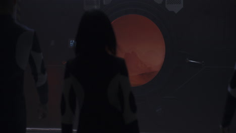 astronauts observing a distant planet through a spacecraft window