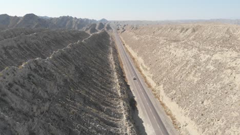 Aerial-Flying-Over-N10-Makran-Coastal-Highway-Road-Beside-Dramatic-Rock-Formations-In-Hingol-National-Park