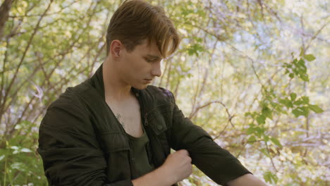 adventurer wearing black jacket, pulls it back and zipping it up in a vibrant and dazzling forest, preparing for the next part of his outdoor journey in the midst of natural surroundings