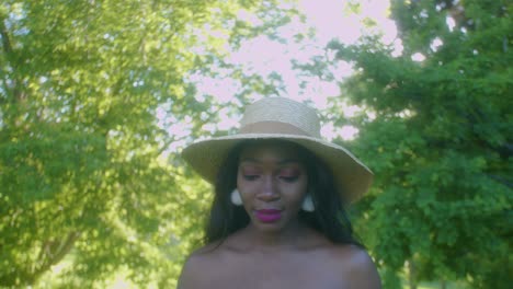 black woman on picnic in park looking up blows kisses sky tilt