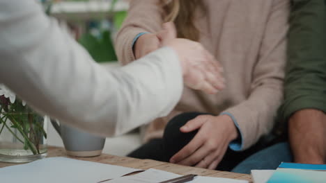 close up hands signing mortgage lease agreement couple meeting real estate agent buying house new home owners purchasing property shaking hands with realtor enjoying investment