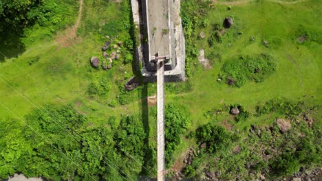 Top-View-Of-A-Suspension-Bridge-Over-The-River-In-Tropical-Countryside