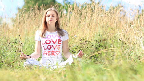 Young girl meditating in city park